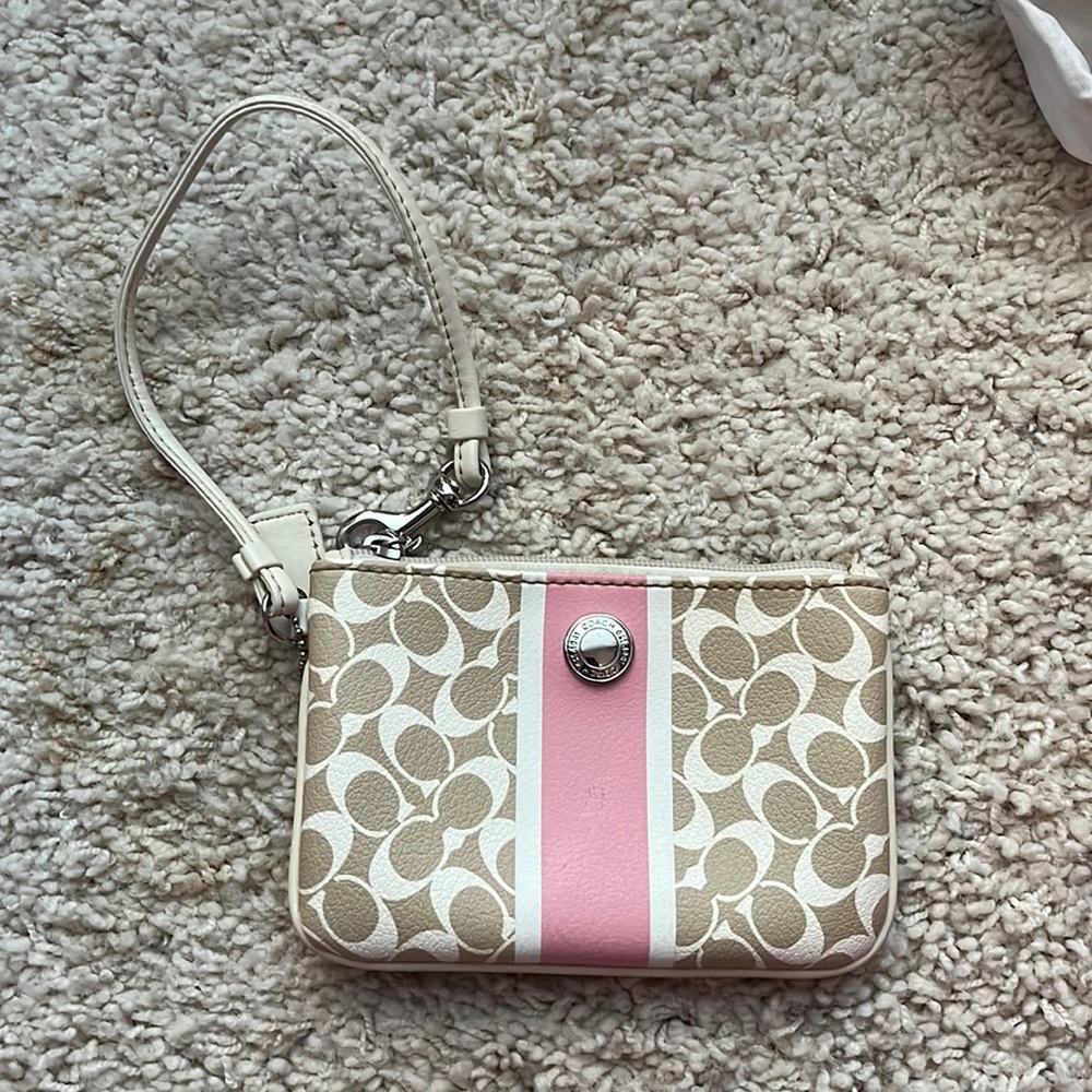 Coach wristlet in excellent condition! One scratch in the middle pink leather.